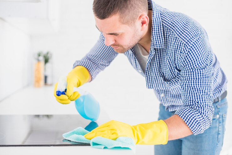 Man cleaning kitchen sulface